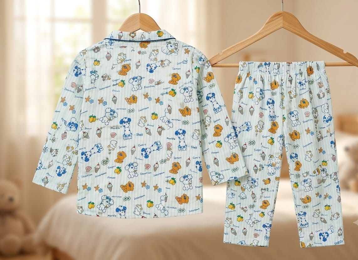 A two-piece children's pajama set hanging on wooden hangers, featuring a long-sleeve button-up top and matching pants in a light blue and white striped fabric with a colorful cartoon dog print.